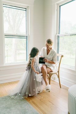 Bride and groom sharing a quiet moment beside tall windows before the ceremony