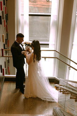 Bride and groom on a staircase in soft daylight