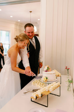 Bride and groom cutting their wedding cake together
